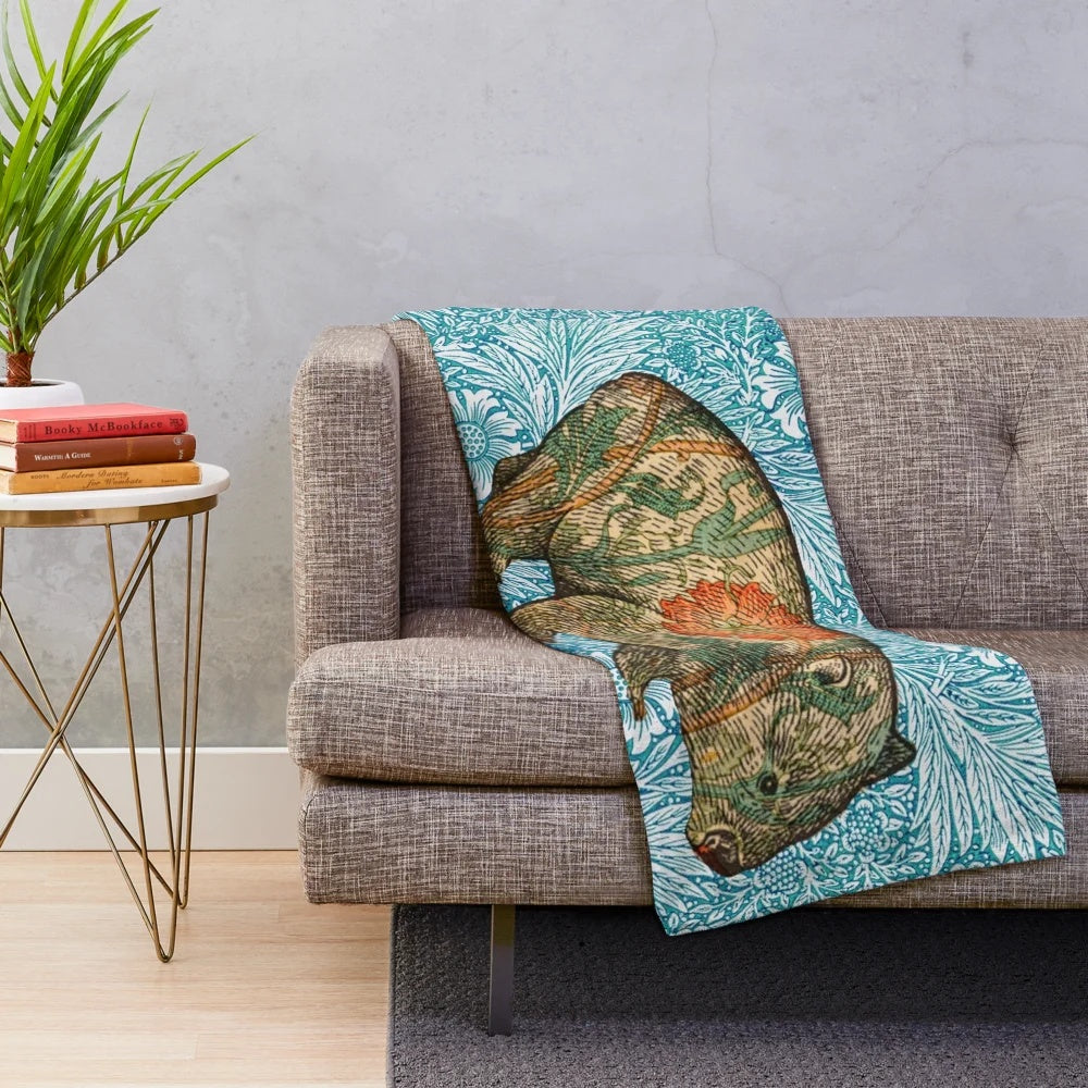 Soft plush blanket featuring a wombat design inspired by Dante Gabriel Rossetti's artwork and William Morris' blue marigold floral pattern