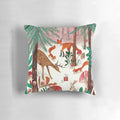 A cozy pink and green pillow featuring whimsical woodland animals in a snowy forest scene