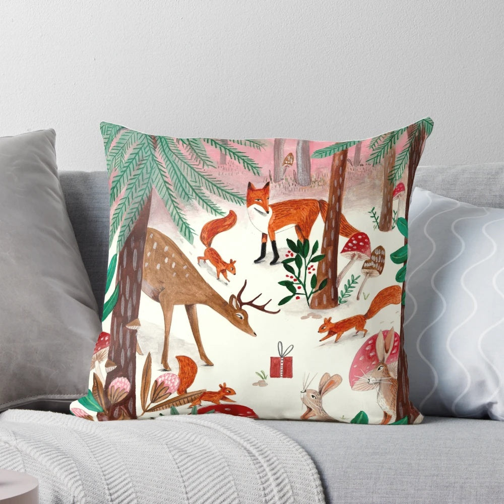 A cozy pink and green pillow featuring whimsical woodland animals in a snowy forest scene