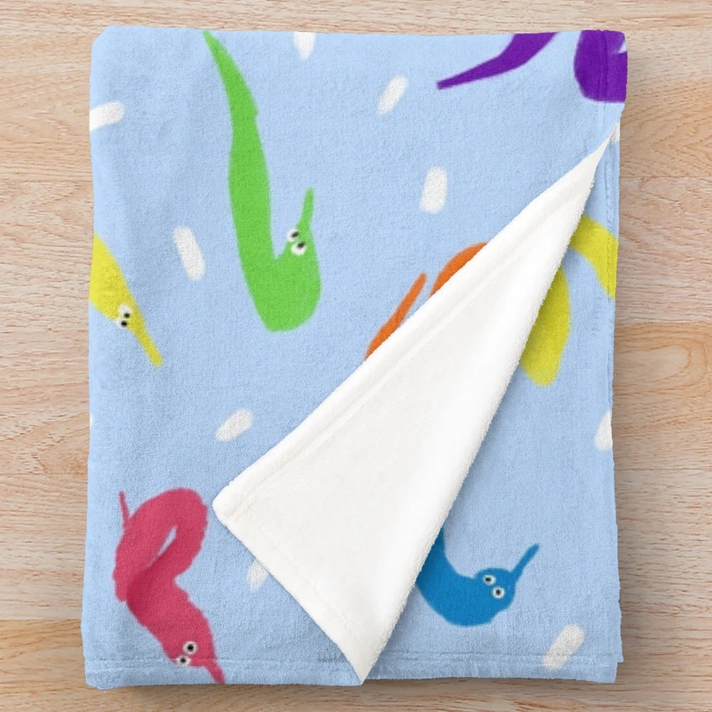 Colorful plush blanket featuring a whimsical worm on a string design