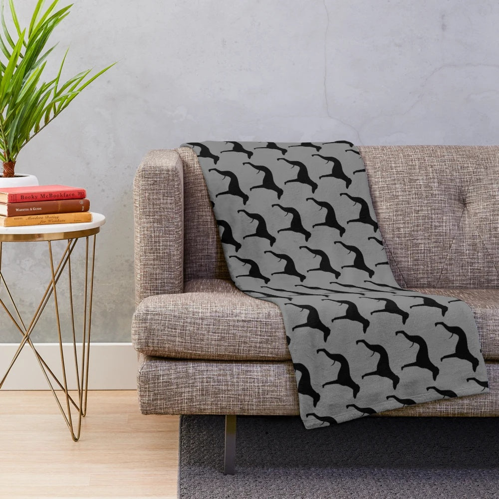 Whippet dog breed silhouette on a plush blanket