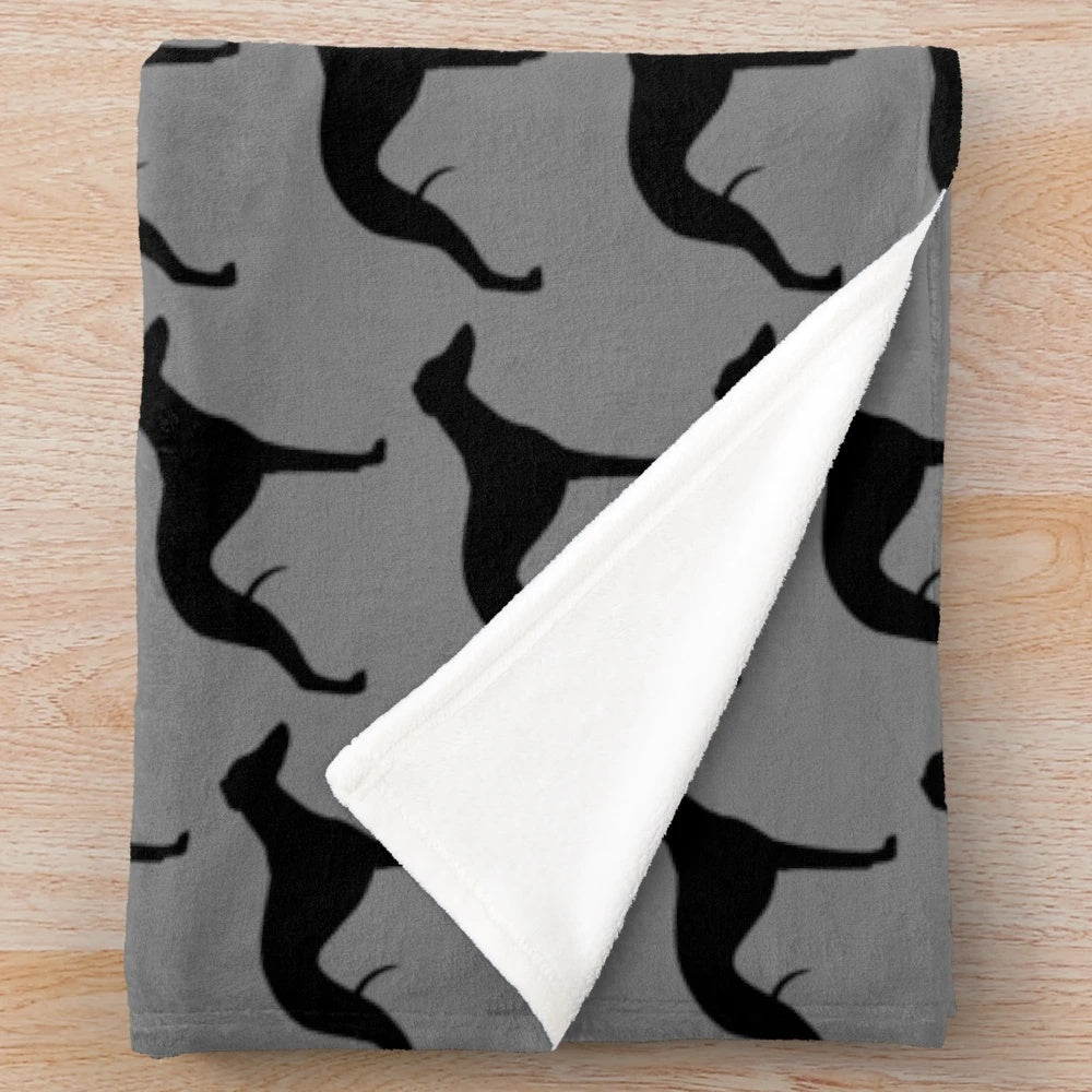 Whippet dog breed silhouette on a plush blanket