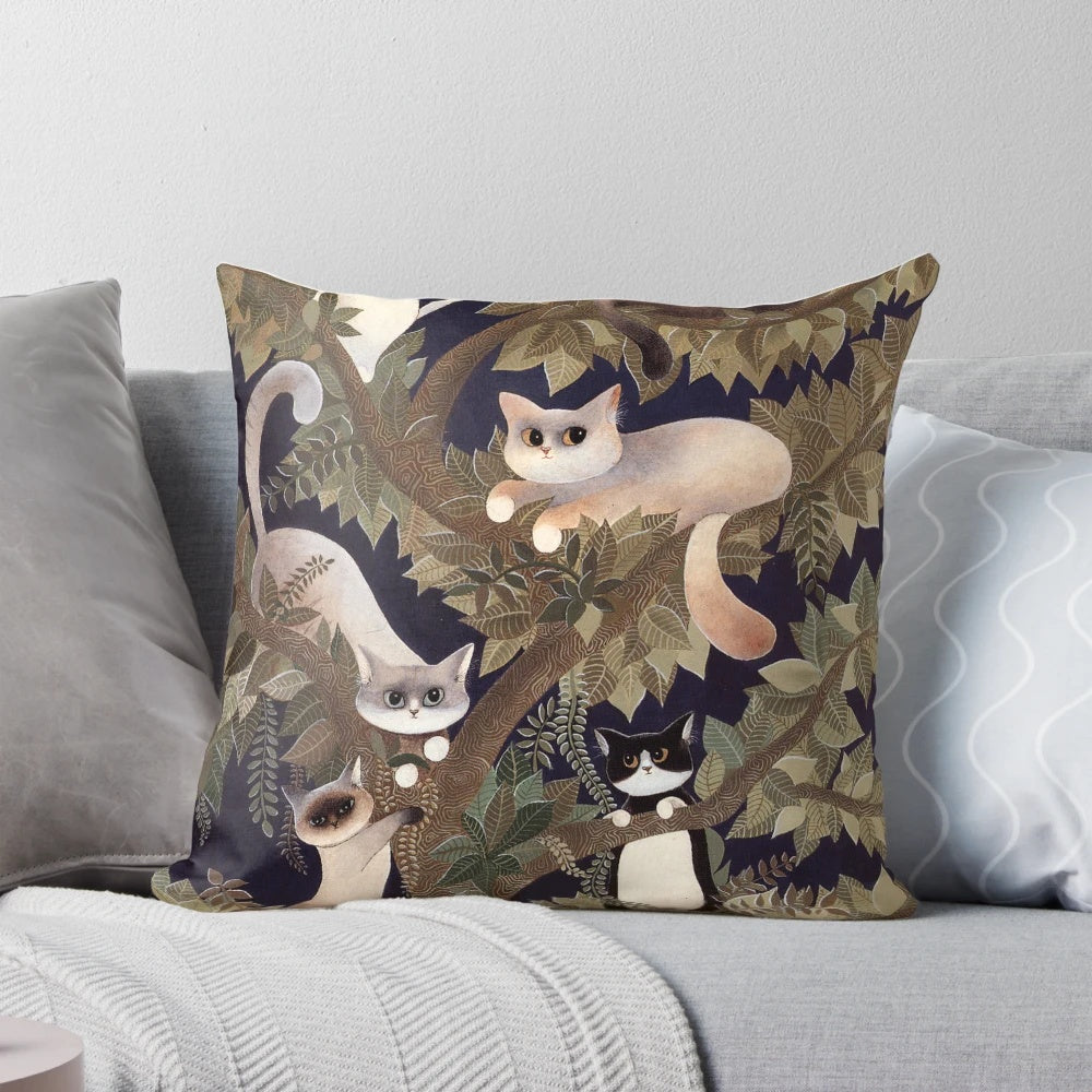 A beautifully designed pillow featuring a tree with whiskered cats in a harmonious symphony