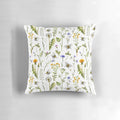 White pillow with an illustration of bees and wildflowers