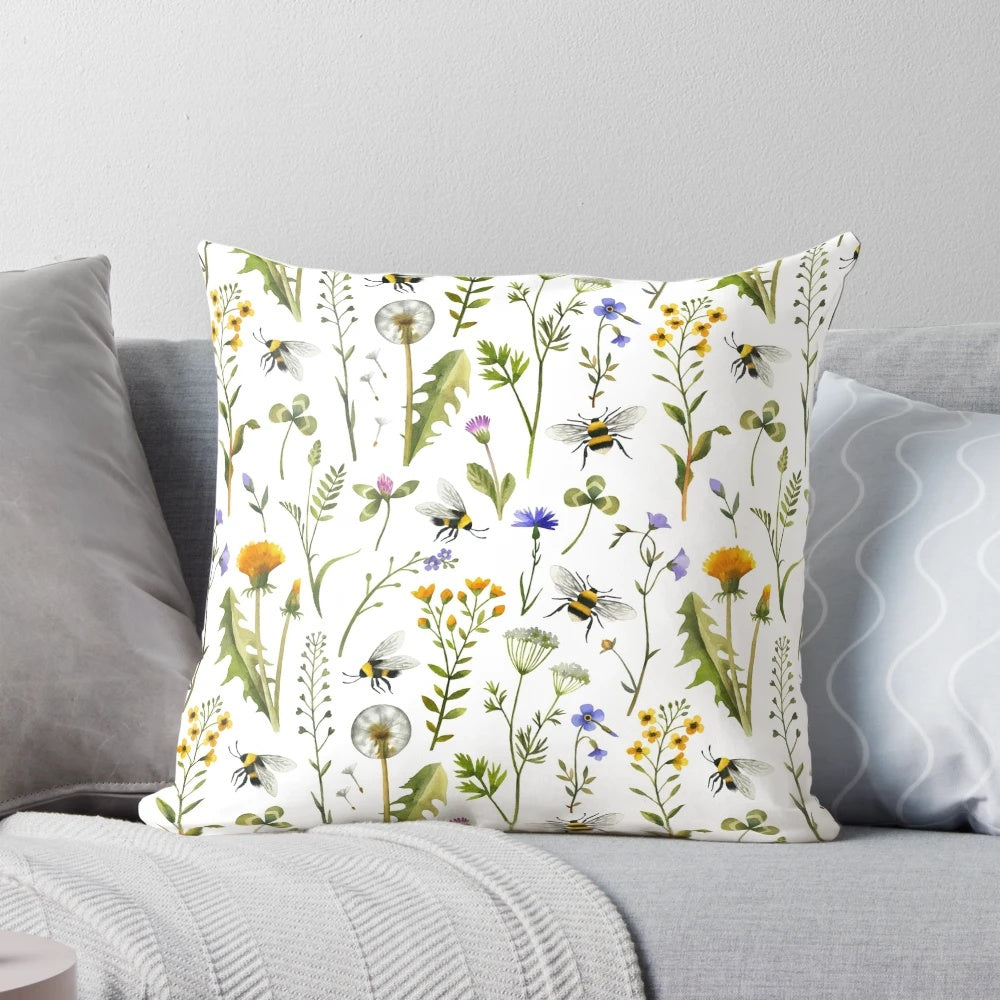 White pillow with an illustration of bees and wildflowers
