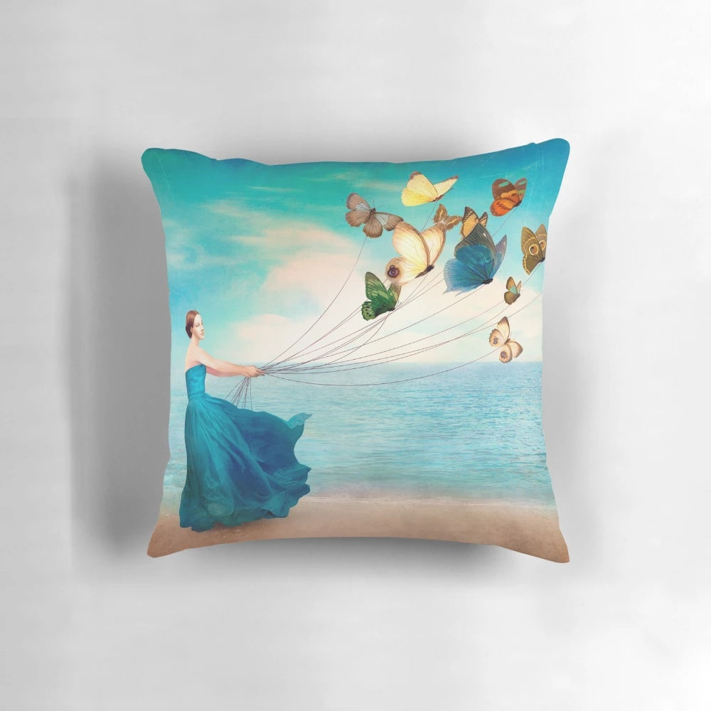 Artistic Wonderland-themed pillow featuring a serene ocean landscape with floating butterflies, designed by artist Christian Schloe.