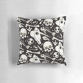 Decorative black and white pillow featuring a collage of skulls, bones, and other natural history curiosities.