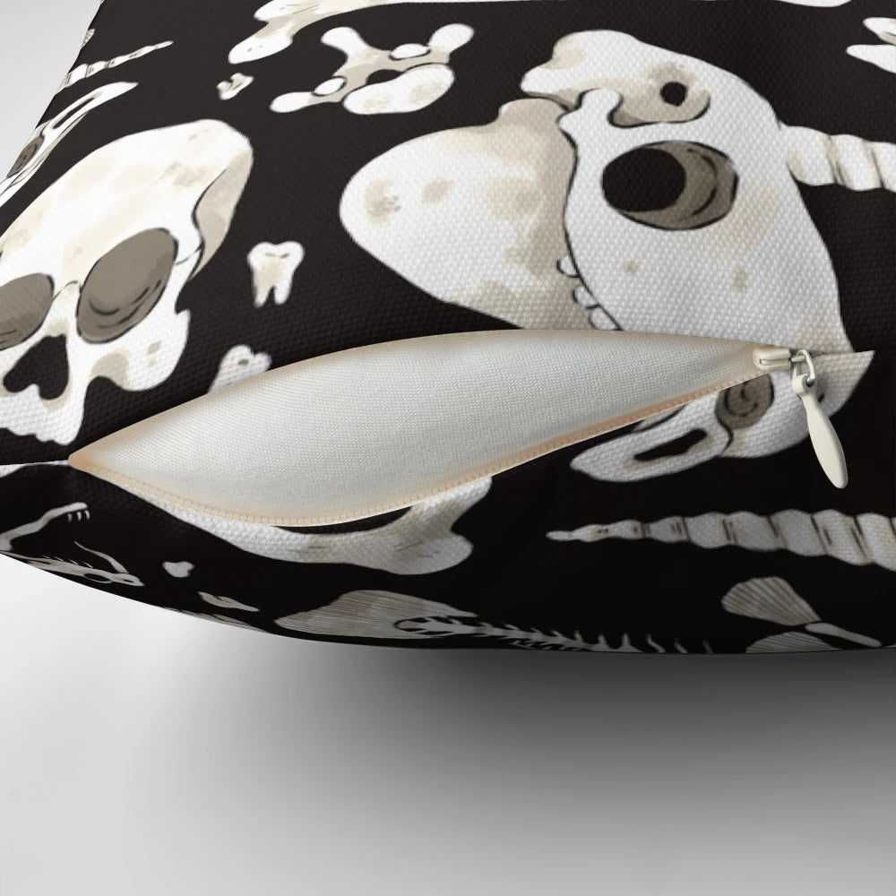 Decorative black and white pillow featuring a collage of skulls, bones, and other natural history curiosities.