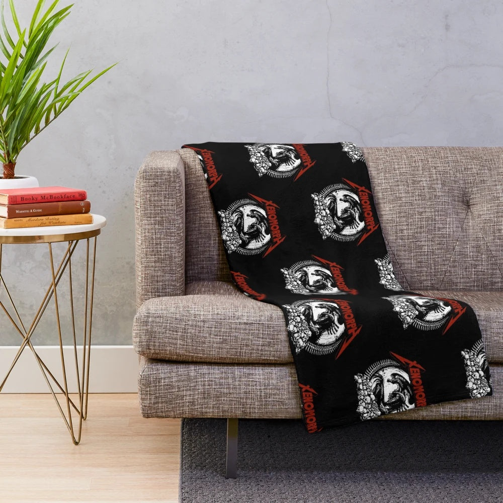 Xenomorph-inspired plush blanket with black and metallic design