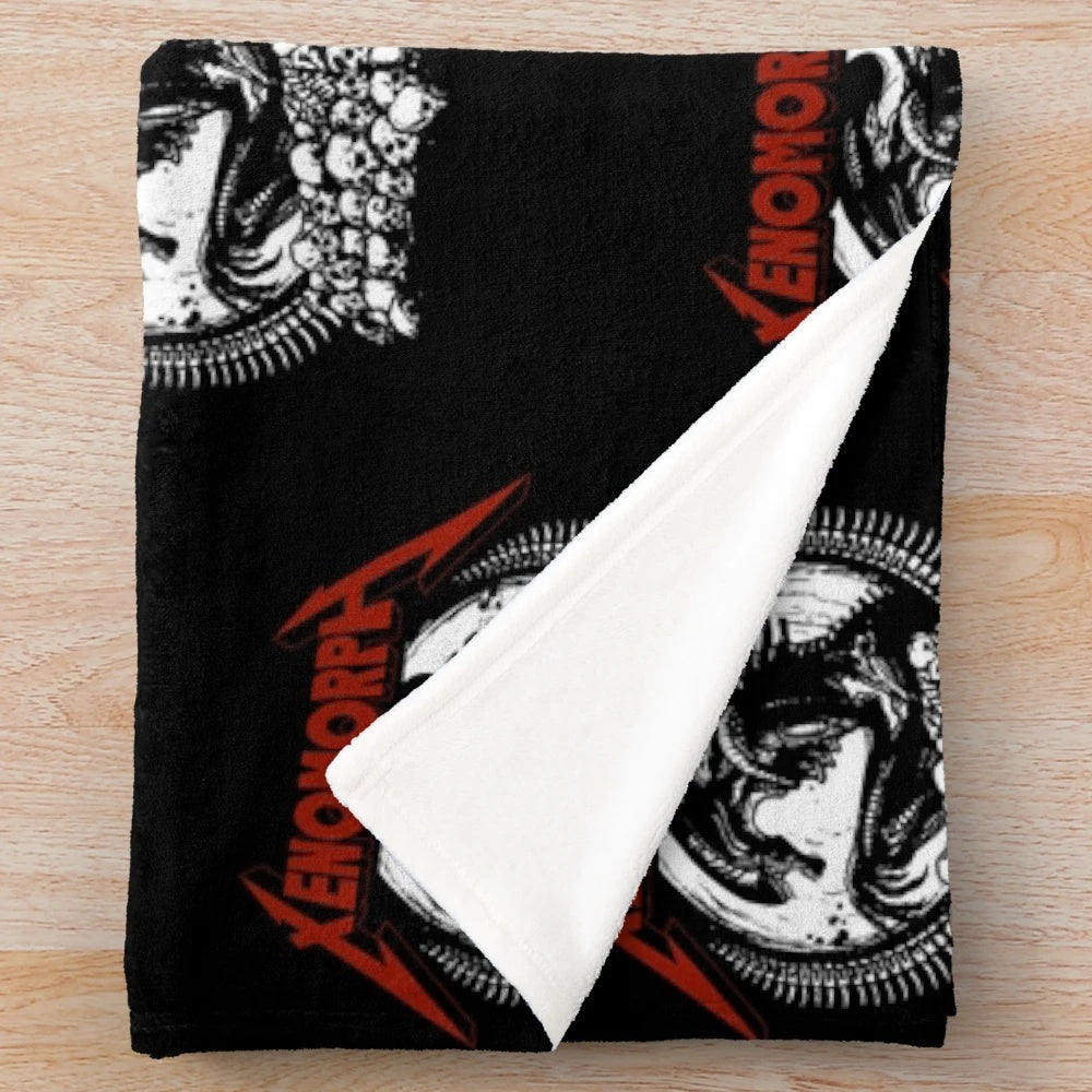 Xenomorph-inspired plush blanket with black and metallic design