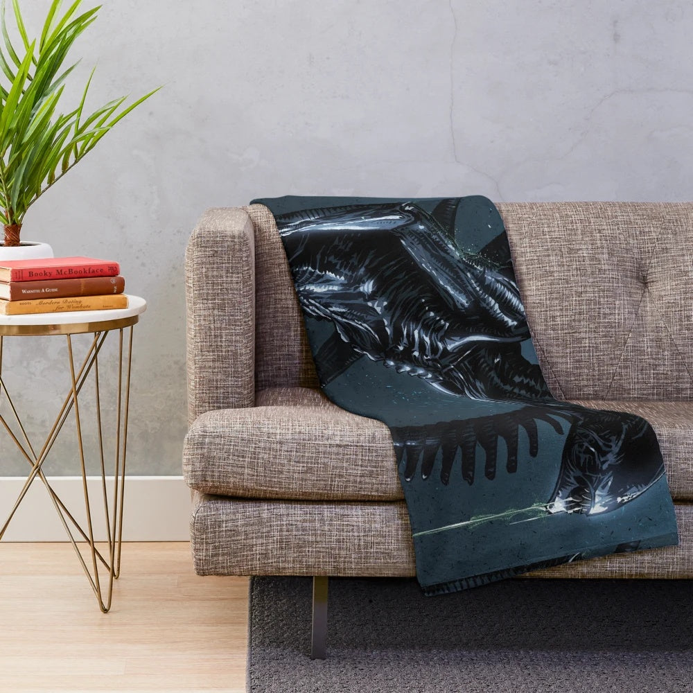 Xenomorph-inspired plush blanket with HR Giger-style alien design