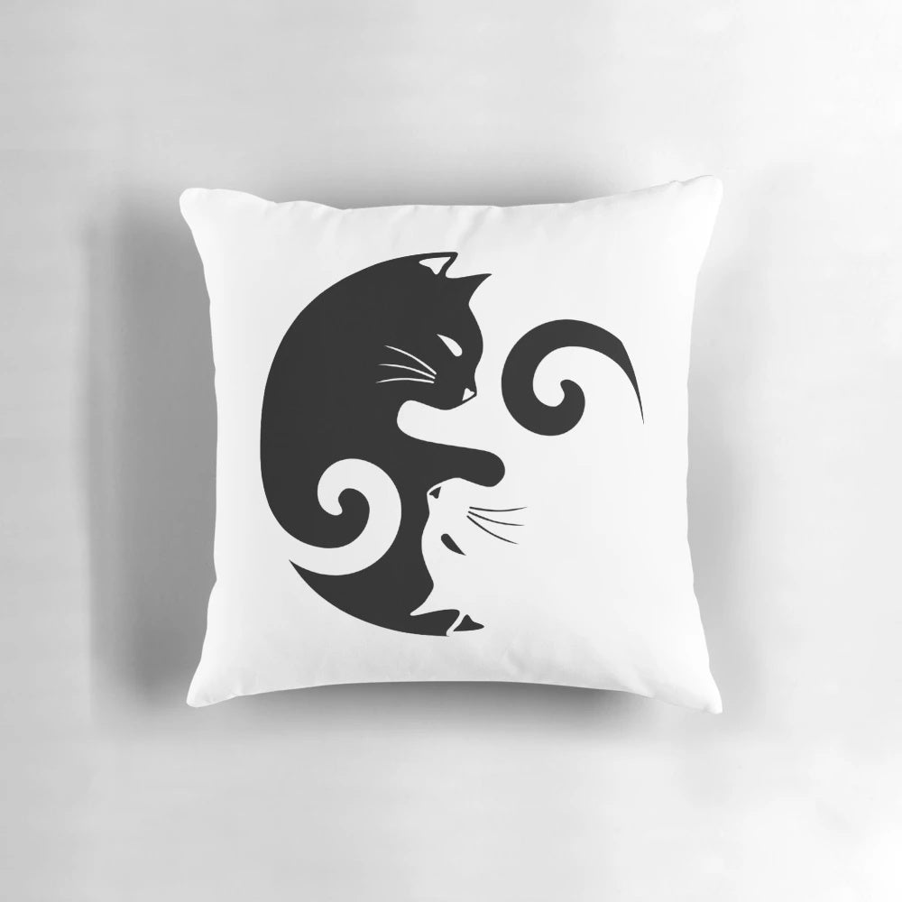 A black and white throw pillow featuring a yin yang cats design illustration