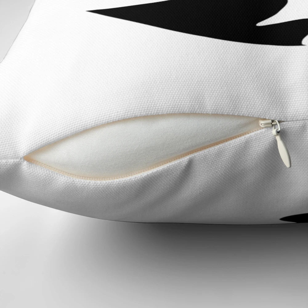 A black and white throw pillow featuring a yin yang cats design illustration
