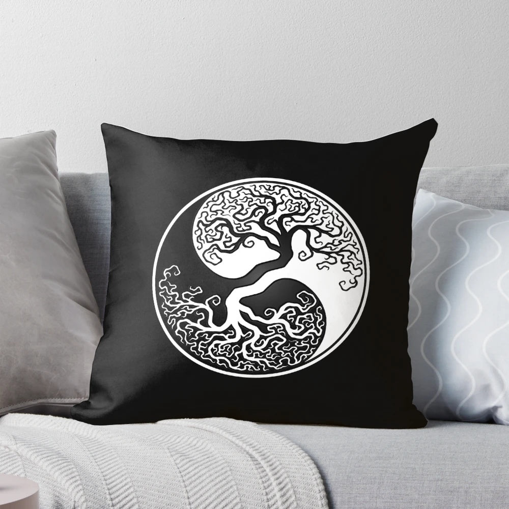 White and black yin yang tree of life design on a decorative pillow