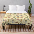 Zelda-inspired yellow plush blanket with Hylian symbols and characters