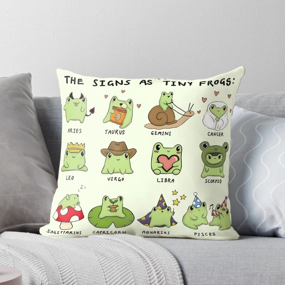 Decorative pillow featuring tiny frog illustrations representing the different zodiac signs